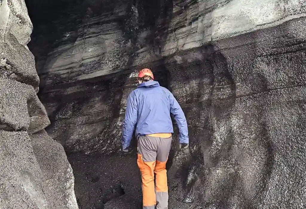A tourist is entering the Katla Icecave Iceland