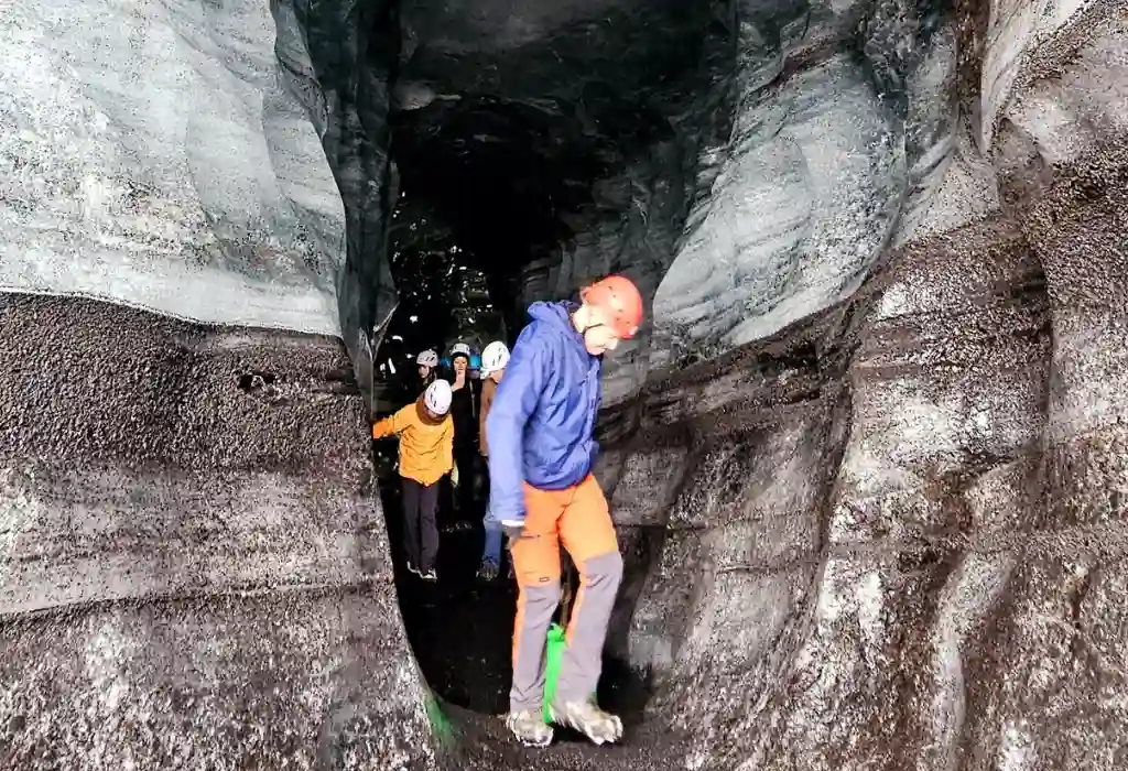 Group of tourists are coming outside from the Katla Icecave Iceland