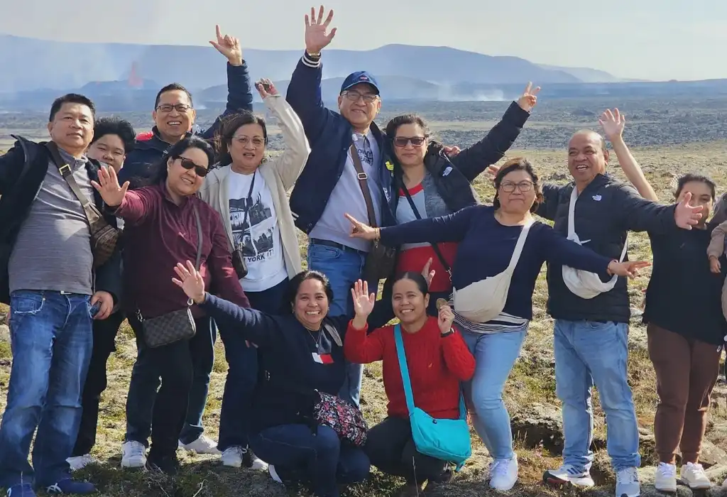 Group of Tourists are cheering up on tour in Iceland